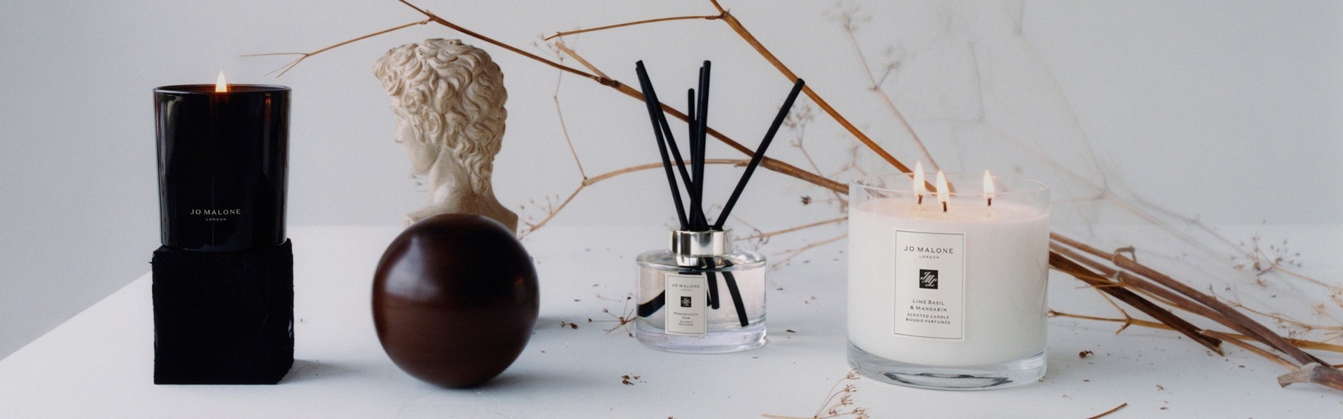 image of mantlepiece with Jo Malone townhouse candle alongside decoration